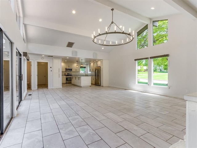 3233 Hickory Stick Rd, Oklahoma City, OK 73120 - unfurnished living room featuring beamed ceiling, high vaulted ceiling, a chandelier, and plenty of natural light