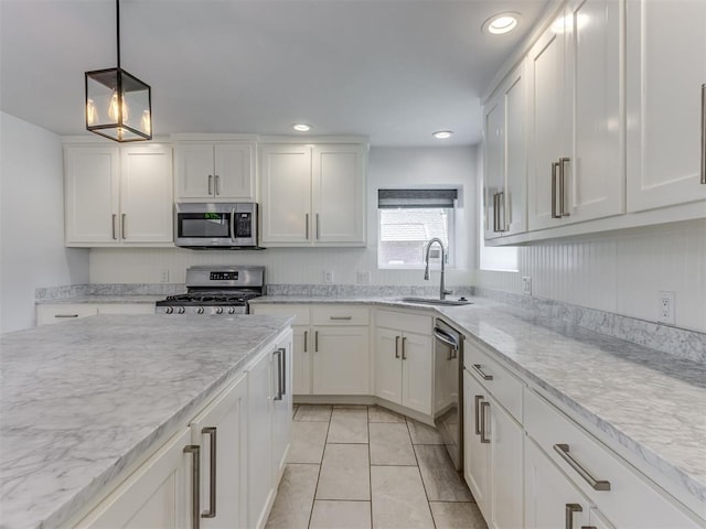 3233 Hickory Stick Rd, Oklahoma City, OK 73120 - kitchen featuring appliances with stainless steel finishes, white cabinetry, pendant lighting, recessed lighting, and light tile patterned floors
