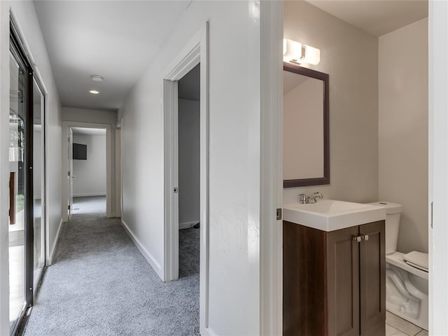 3233 Hickory Stick Rd, Oklahoma City, OK 73120 - hallway featuring light carpet and baseboards