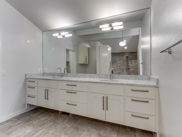 3233 Hickory Stick Rd, Oklahoma City, OK 73120 - bathroom featuring vaulted ceiling, double vanity, and tiled shower