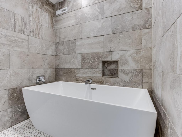 3233 Hickory Stick Rd, Oklahoma City, OK 73120 - bathroom with tile walls and a freestanding tub