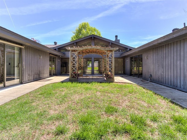 3233 Hickory Stick Rd, Oklahoma City, OK 73120 - back of property featuring a patio and a lawn