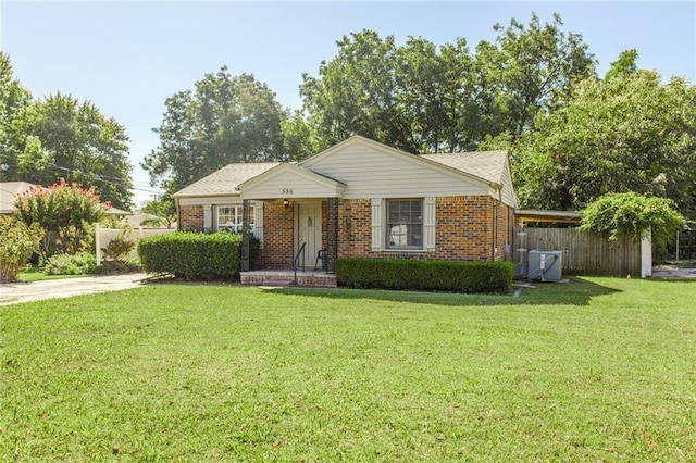 556 SW 52nd St, Oklahoma City, OK 73109 - ranch-style home with fence, central AC unit, a front lawn, and brick siding