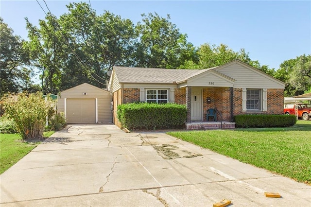 556 SW 52nd St, Oklahoma City, OK 73109 - ranch-style home featuring a front lawn, brick siding, a garage, concrete driveway, and an outdoor structure