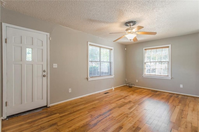 556 SW 52nd St, Oklahoma City, OK 73109 - foyer entrance with ceiling fan, light wood-type flooring, a textured ceiling, and a wealth of natural light