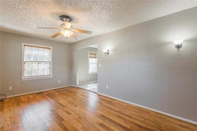 556 SW 52nd St, Oklahoma City, OK 73109 - empty room featuring light wood-type flooring, a textured ceiling, baseboards, and ceiling fan