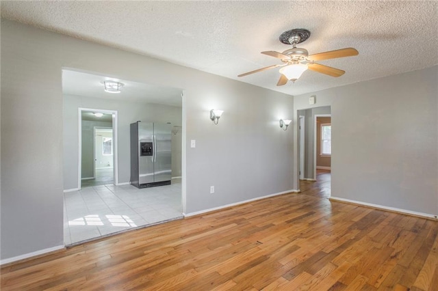 556 SW 52nd St, Oklahoma City, OK 73109 - empty room with baseboards, a textured ceiling, ceiling fan, and wood finished floors