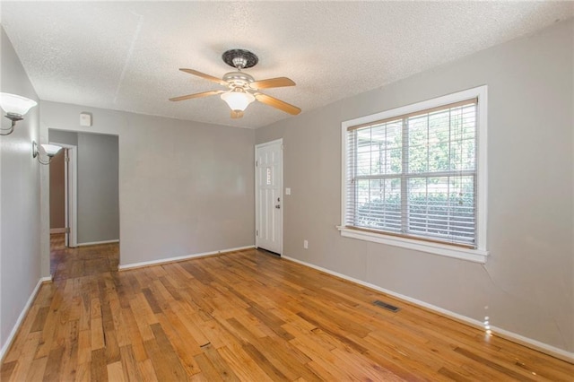 556 SW 52nd St, Oklahoma City, OK 73109 - empty room featuring visible vents, a textured ceiling, and wood finished floors