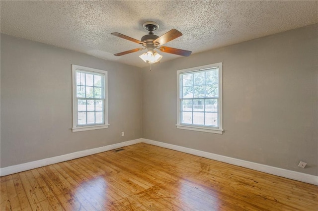 556 SW 52nd St, Oklahoma City, OK 73109 - spare room with a ceiling fan, baseboards, wood finished floors, and a textured ceiling