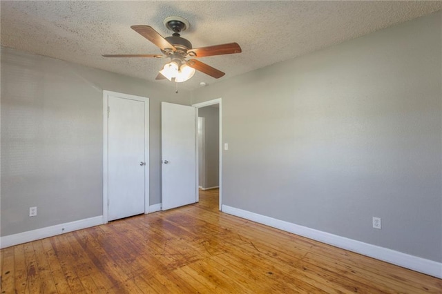 556 SW 52nd St, Oklahoma City, OK 73109 - unfurnished bedroom featuring baseboards, a textured ceiling, and wood finished floors