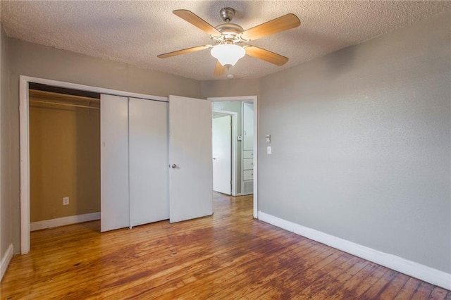 556 SW 52nd St, Oklahoma City, OK 73109 - unfurnished bedroom with a textured ceiling, baseboards, wood finished floors, and a closet