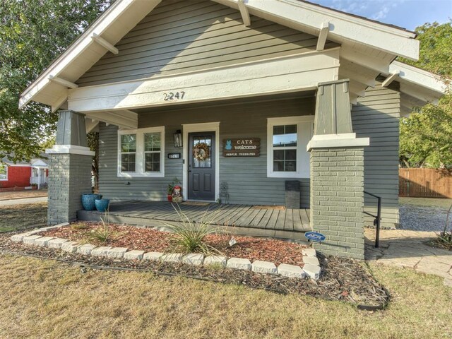 2247 NW 35th St, Oklahoma City, OK 73112 - view of front of house featuring a porch and fence