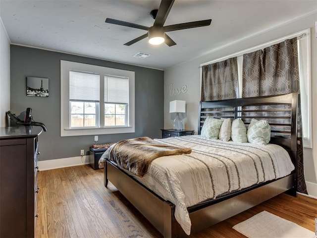 2247 NW 35th St, Oklahoma City, OK 73112 - bedroom with baseboards, ceiling fan, wood finished floors, and visible vents
