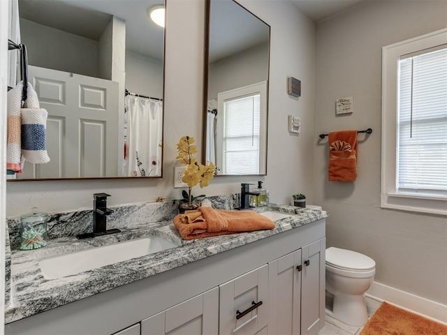 2247 NW 35th St, Oklahoma City, OK 73112 - bathroom with toilet, a healthy amount of sunlight, and a sink