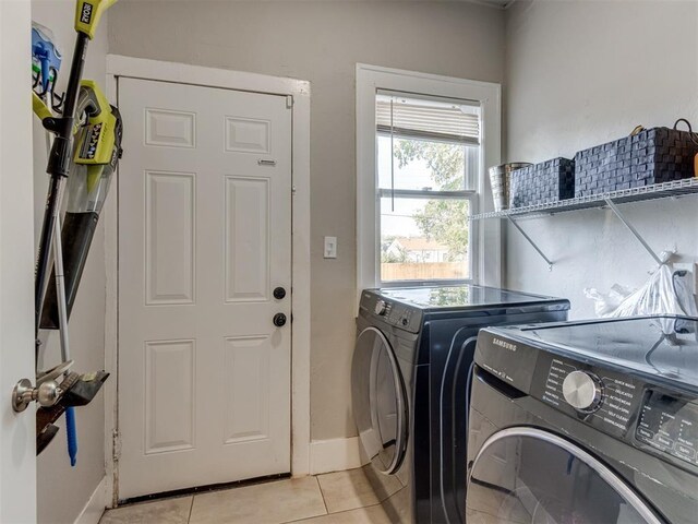 2247 NW 35th St, Oklahoma City, OK 73112 - clothes washing area featuring baseboards, laundry area, washing machine and dryer, and light tile patterned flooring