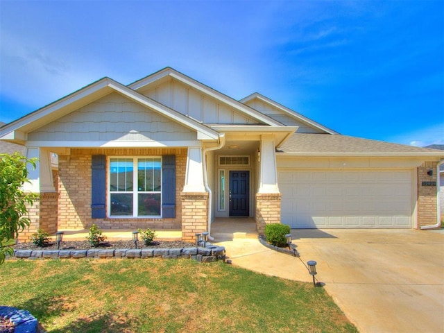 craftsman inspired home featuring brick siding, board and batten siding, an attached garage, and concrete driveway