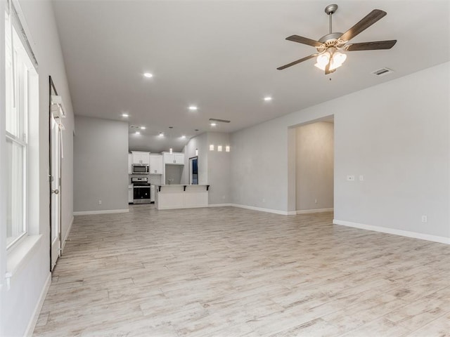 unfurnished living room with visible vents, light wood-style floors, baseboards, ceiling fan, and recessed lighting