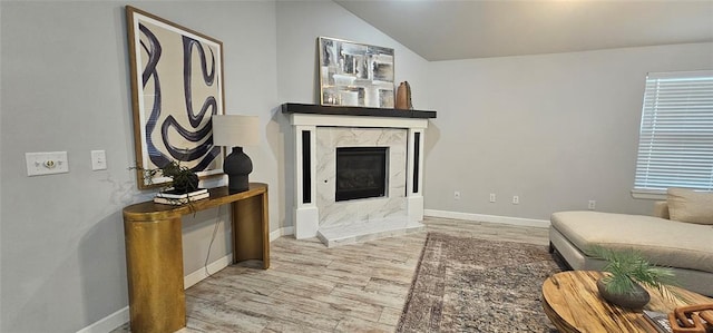 12929 NW 4th St, Yukon, OK 73099 - living room with wood finished floors, a fireplace, vaulted ceiling, and baseboards
