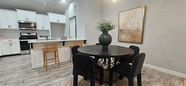 12929 NW 4th St, Yukon, OK 73099 - dining room with light wood-type flooring and baseboards