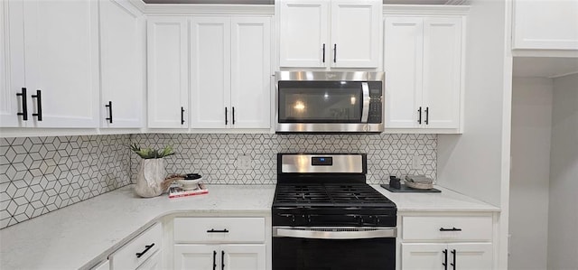 12929 NW 4th St, Yukon, OK 73099 - kitchen featuring appliances with stainless steel finishes, white cabinets, and decorative backsplash