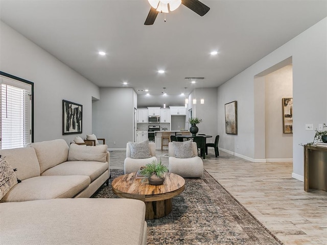 12929 NW 4th St, Yukon, OK 73099 - living area with light wood-style floors, a ceiling fan, and recessed lighting