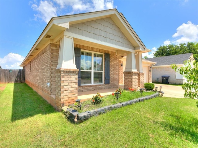 12929 NW 4th St, Yukon, OK 73099 - view of front of property with brick siding, an attached garage, driveway, and a porch