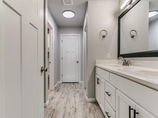 12929 NW 4th St, Yukon, OK 73099 - bathroom with double vanity and wood finished floors