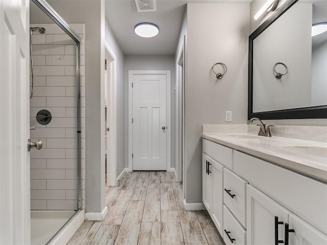 12929 NW 4th St, Yukon, OK 73099 - full bath with a stall shower, double vanity, and wood finished floors