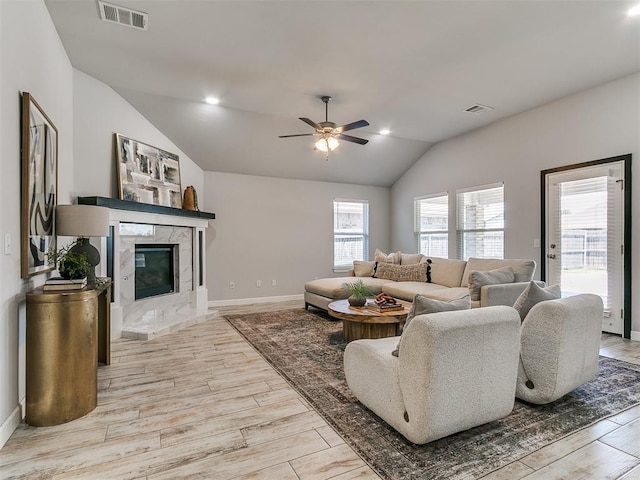 12929 NW 4th St, Yukon, OK 73099 - living room featuring vaulted ceiling, a ceiling fan, wood finished floors, and a fireplace
