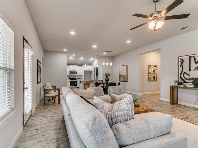 12929 NW 4th St, Yukon, OK 73099 - living room featuring light wood-type flooring, a ceiling fan, and recessed lighting