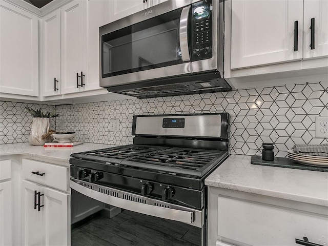 12929 NW 4th St, Yukon, OK 73099 - kitchen with stainless steel appliances, decorative backsplash, white cabinetry, and light stone counters