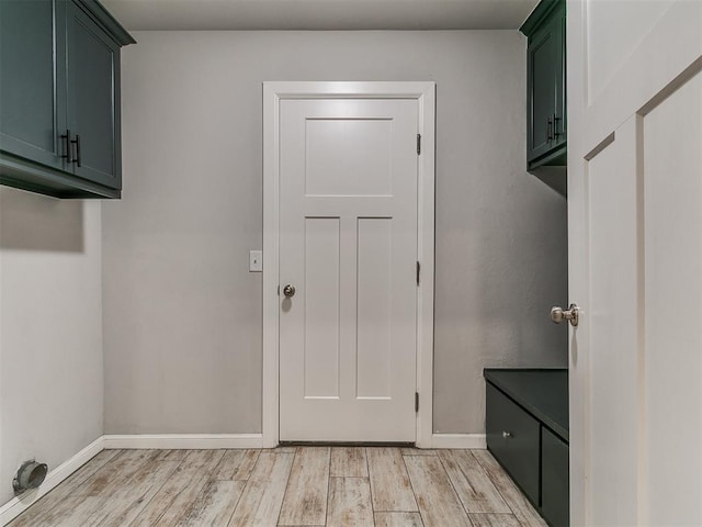 12929 NW 4th St, Yukon, OK 73099 - laundry area featuring light wood finished floors and cabinet space