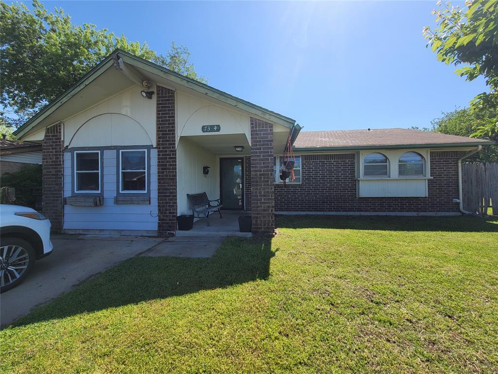 7304 S Brookline Ave, Oklahoma City, OK 73159 - view of front facade with brick siding and a front yard