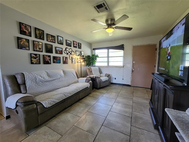 living room featuring a ceiling fan, tile patterned floors, and visible vents