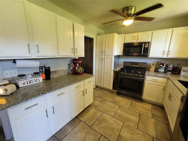 kitchen with ceiling fan, light stone countertops, light tile patterned floors, stainless steel appliances, and white cabinetry