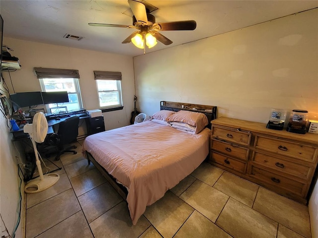 bedroom featuring light tile patterned floors, a ceiling fan, and visible vents