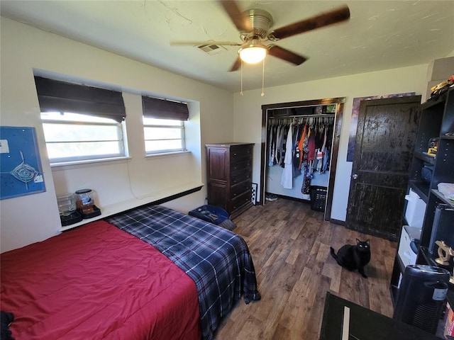 bedroom featuring ceiling fan, visible vents, and wood finished floors