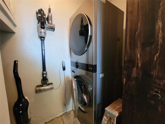 washroom featuring laundry area and stacked washing maching and dryer