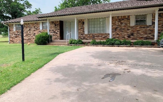 310 Walter Way, Anadarko, OK 73005 - ranch-style home featuring a porch, brick siding, and a front yard