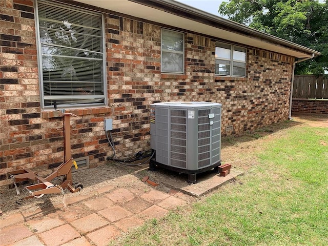 310 Walter Way, Anadarko, OK 73005 - exterior details featuring cooling unit, brick siding, and fence