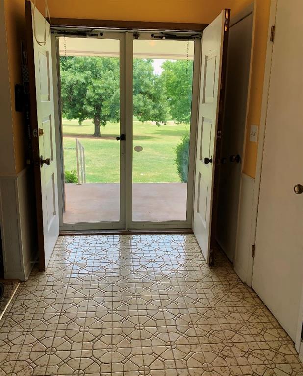 310 Walter Way, Anadarko, OK 73005 - doorway to outside featuring light floors and plenty of natural light