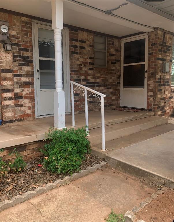 310 Walter Way, Anadarko, OK 73005 - view of exterior entry with covered porch and brick siding