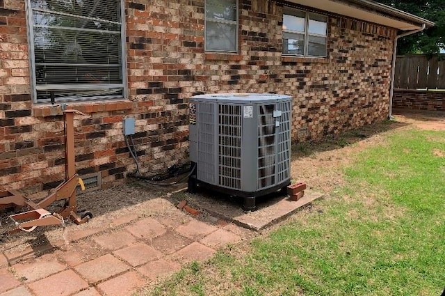 310 Walter Way, Anadarko, OK 73005 - exterior details with fence, central AC, and brick siding