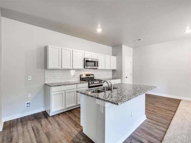 kitchen featuring a sink, stainless steel appliances, dark wood finished floors, and visible vents