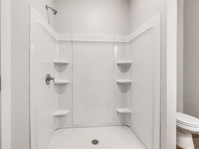 full bathroom with toilet and walk in shower