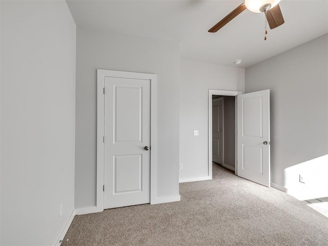 unfurnished bedroom with baseboards, carpet flooring, and ceiling fan