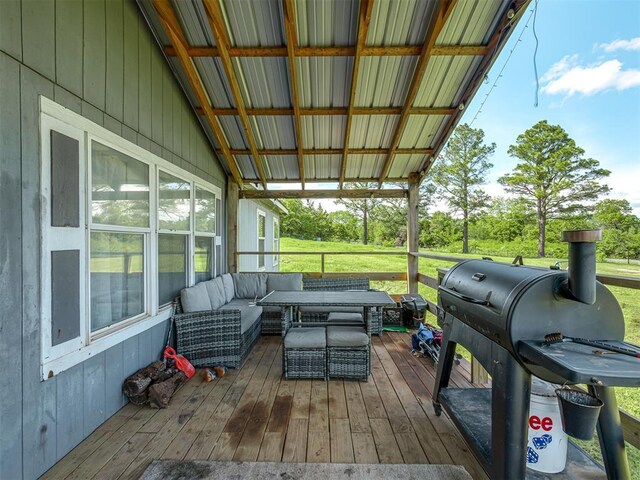 wooden terrace featuring outdoor lounge area and a grill