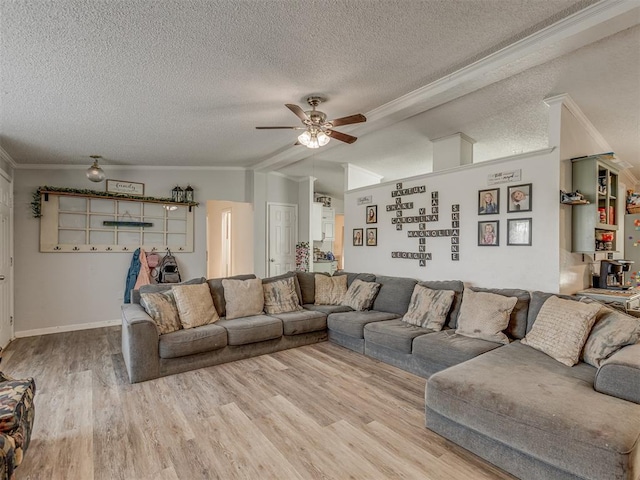 living room featuring a ceiling fan, a textured ceiling, vaulted ceiling, wood finished floors, and ornamental molding