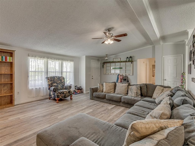 living area with lofted ceiling, light wood-style floors, baseboards, a textured ceiling, and a ceiling fan