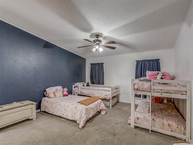 bedroom featuring carpet floors, a ceiling fan, a textured ceiling, and a textured wall